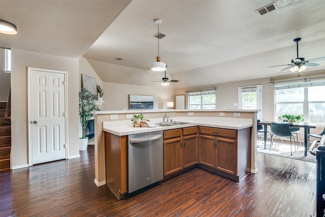 kitchen with hanging light fixtures, a center island with sink, stainless steel dishwasher, dark hardwood / wood-style floors, and sink