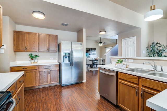 kitchen featuring dark hardwood / wood-style flooring, ceiling fan, sink, pendant lighting, and stainless steel appliances