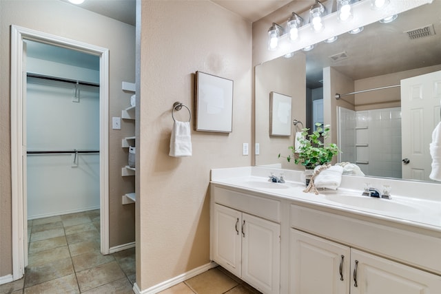 bathroom with vanity, a shower, and tile patterned flooring