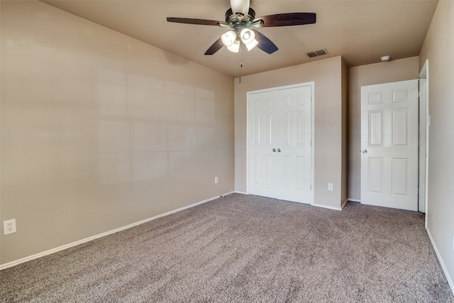 unfurnished bedroom featuring carpet flooring, a closet, and ceiling fan