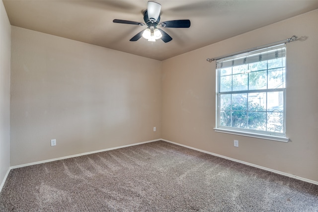 spare room featuring carpet and ceiling fan