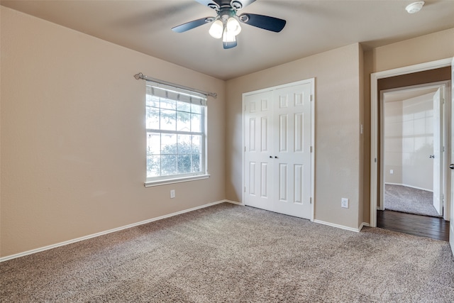 unfurnished bedroom with carpet flooring, a closet, and ceiling fan