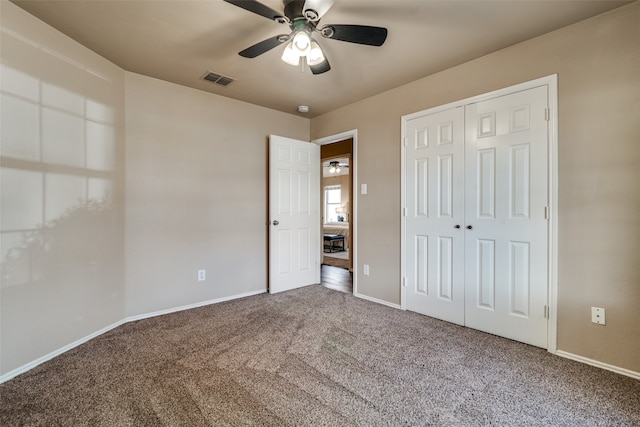 unfurnished bedroom featuring a closet, ceiling fan, and carpet