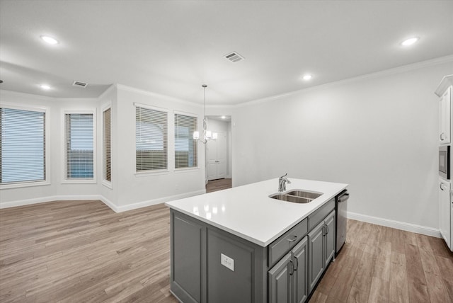 kitchen featuring gray cabinetry, sink, light hardwood / wood-style flooring, an island with sink, and appliances with stainless steel finishes