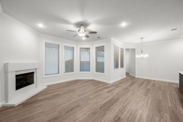 unfurnished living room with light hardwood / wood-style floors, ceiling fan with notable chandelier, and ornamental molding