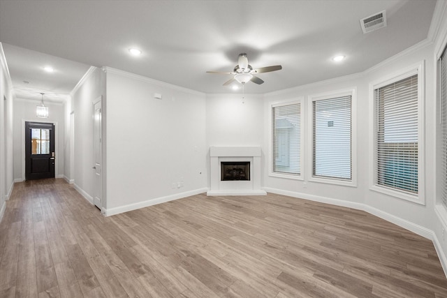 unfurnished living room with ceiling fan, light hardwood / wood-style floors, and ornamental molding