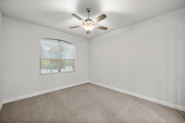 empty room with ceiling fan and carpet floors