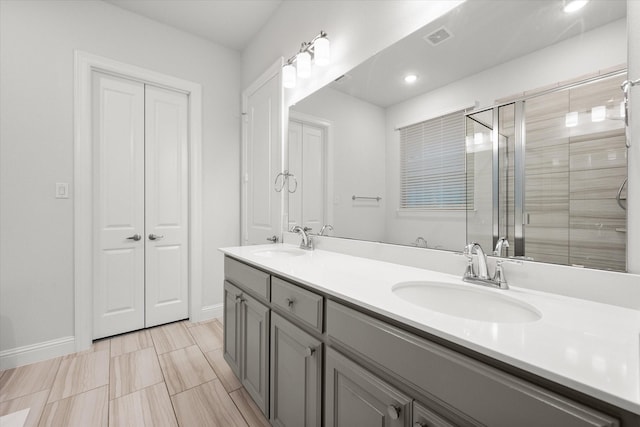 bathroom featuring vanity and a shower with shower door