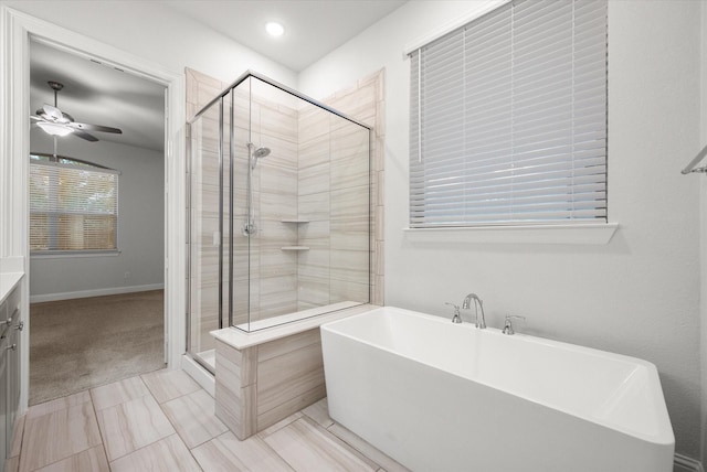 bathroom featuring separate shower and tub, ceiling fan, and tile patterned flooring