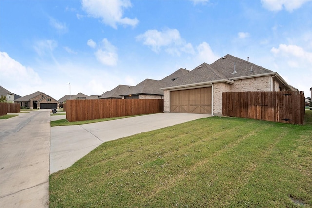 view of front of house featuring a garage and a front lawn