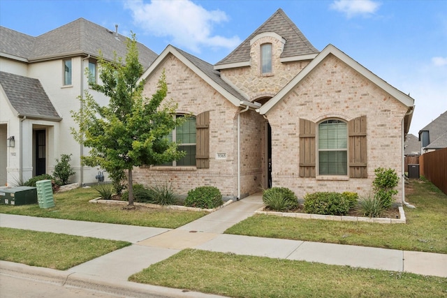 french country inspired facade with a front lawn