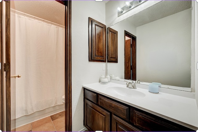 full bathroom with tile patterned flooring, shower / bath combination with curtain, a textured ceiling, toilet, and vanity