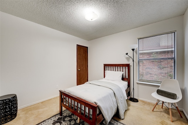 carpeted bedroom with a textured ceiling