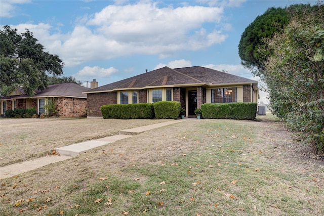 ranch-style home with central AC and a front yard