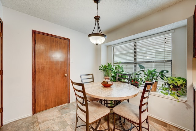 dining room with a textured ceiling