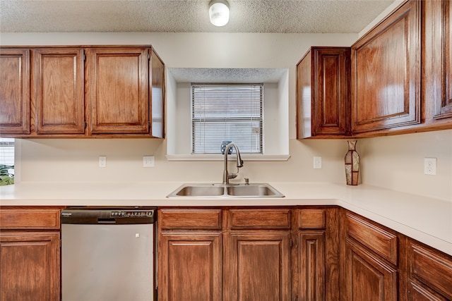 kitchen featuring dishwasher, a textured ceiling, and sink