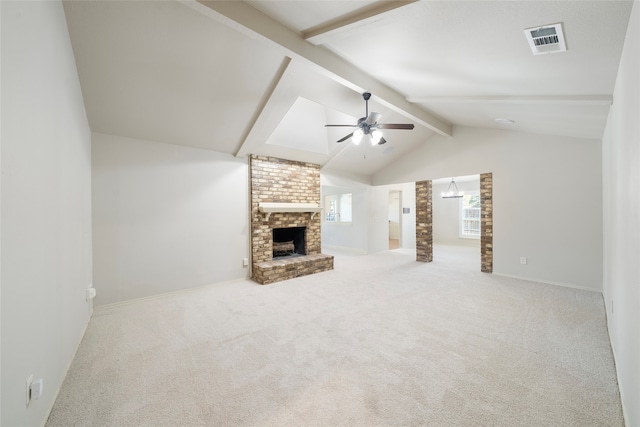 unfurnished living room featuring light carpet, ceiling fan, vaulted ceiling with beams, and a brick fireplace