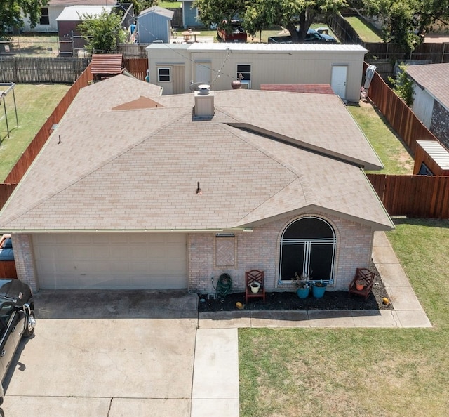 view of front of house with a front yard and a garage