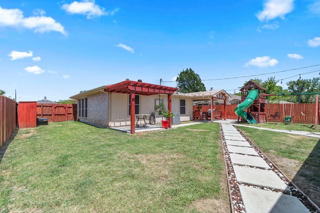 rear view of house featuring a patio area, a playground, and a yard