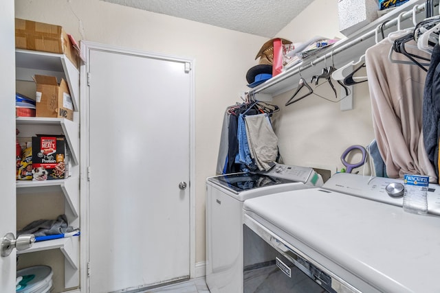 laundry room featuring independent washer and dryer and a textured ceiling