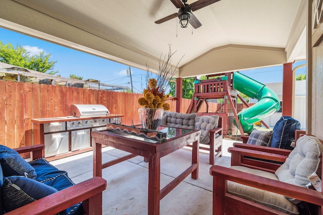 view of patio / terrace featuring area for grilling, ceiling fan, a playground, and a grill