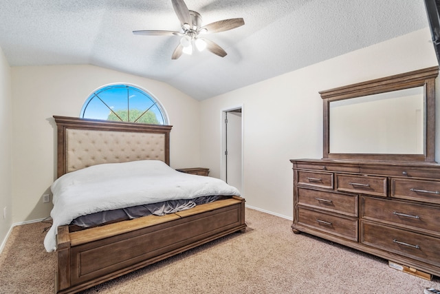 bedroom featuring ceiling fan, light carpet, a textured ceiling, and vaulted ceiling