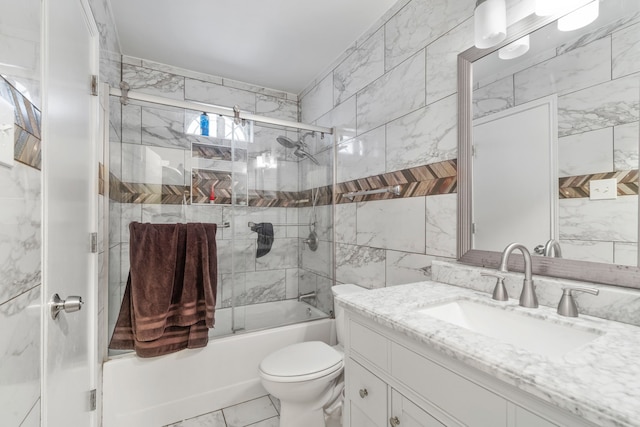 full bathroom with vanity, bath / shower combo with glass door, and toilet