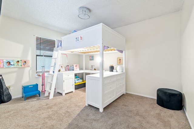 bedroom with a textured ceiling and light colored carpet