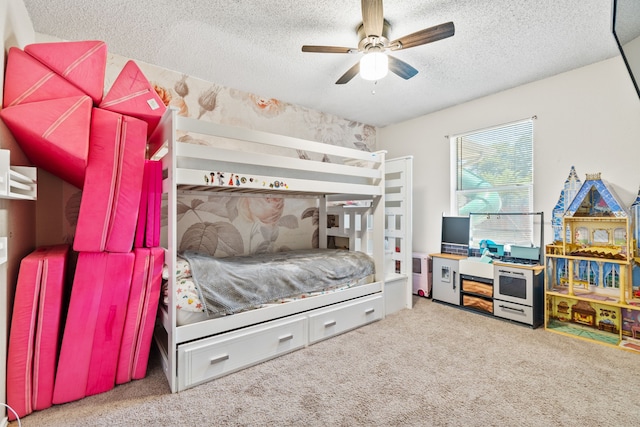 carpeted bedroom featuring ceiling fan and a textured ceiling