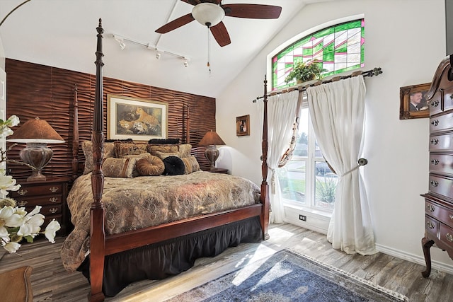 bedroom with hardwood / wood-style flooring, ceiling fan, and lofted ceiling