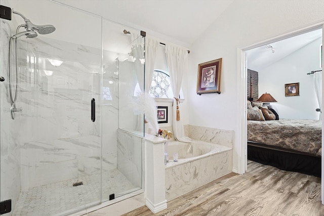 bathroom with wood-type flooring, separate shower and tub, and lofted ceiling