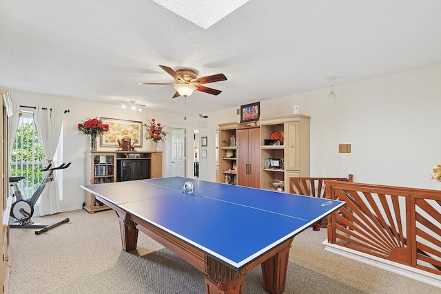 playroom with a textured ceiling, ceiling fan, and carpet floors