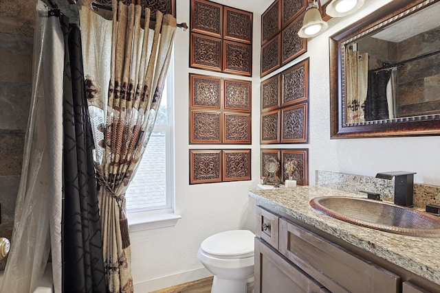 bathroom with hardwood / wood-style floors, walk in shower, vanity, and toilet