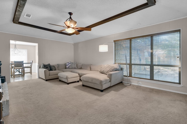 carpeted living room with ceiling fan, a textured ceiling, and ornamental molding