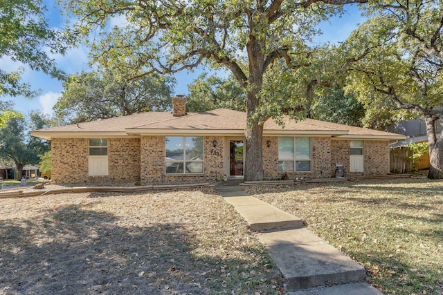 ranch-style home with a front lawn