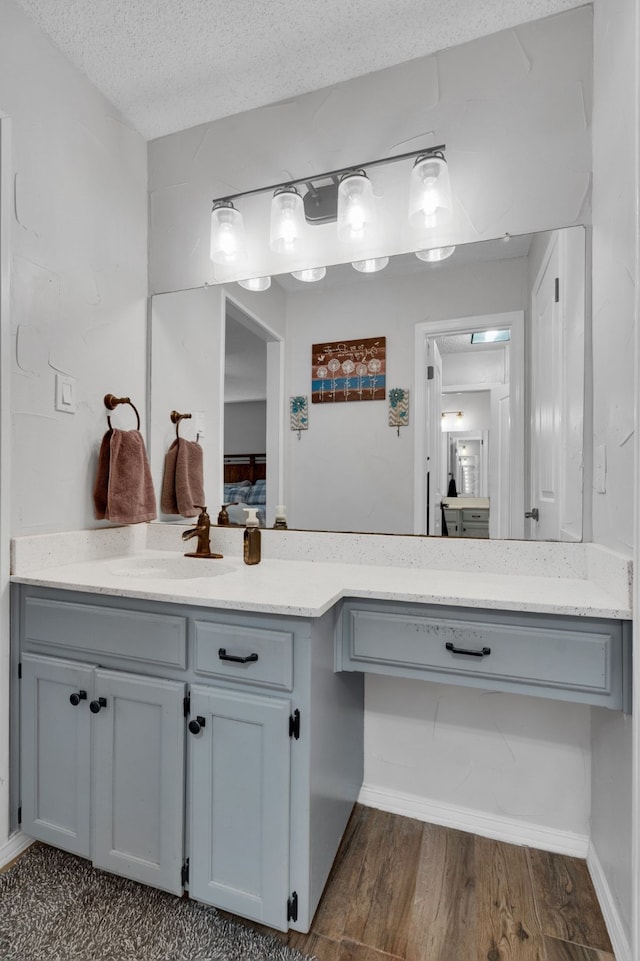 bathroom featuring vanity, a textured ceiling, and wood-type flooring