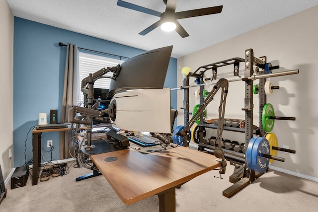 exercise area with light carpet, a textured ceiling, and ceiling fan