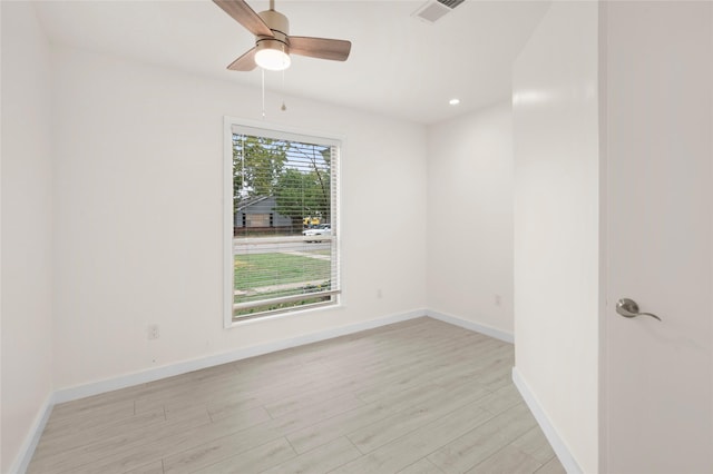 spare room featuring ceiling fan and light hardwood / wood-style flooring