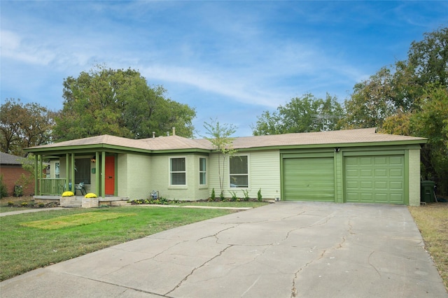 ranch-style house featuring a garage, a front lawn, and covered porch