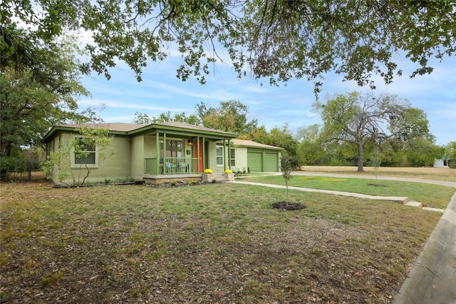 single story home with a porch, a garage, and a front lawn