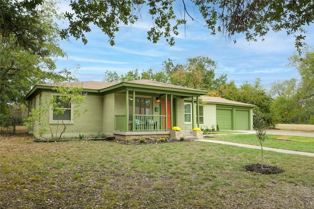 ranch-style house featuring covered porch, a front lawn, and a garage