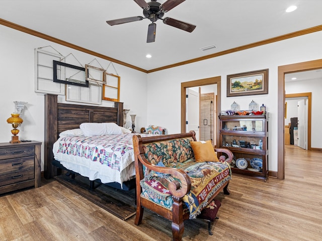 bedroom with hardwood / wood-style floors, crown molding, and ceiling fan