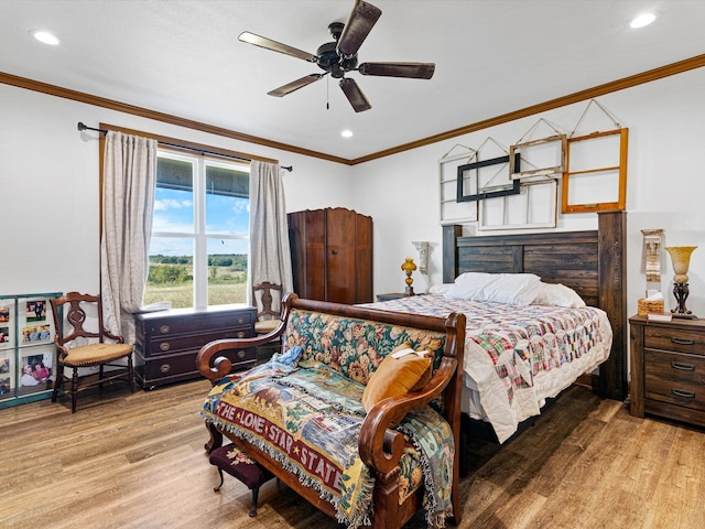 bedroom with crown molding, light hardwood / wood-style floors, and ceiling fan