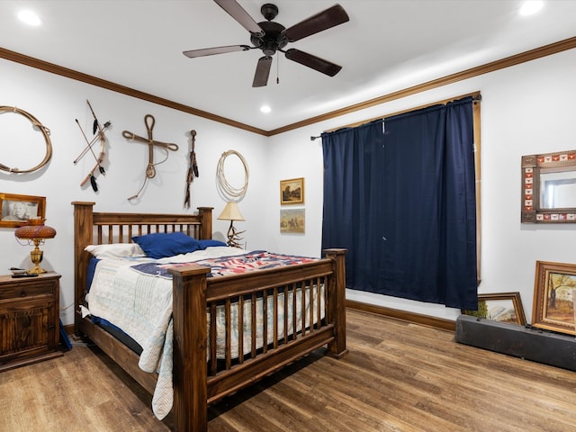 bedroom with ornamental molding, hardwood / wood-style floors, and ceiling fan