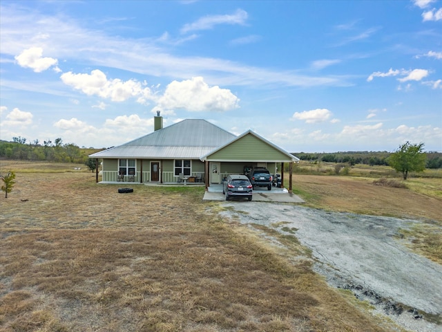 view of front of house featuring covered porch and a carport