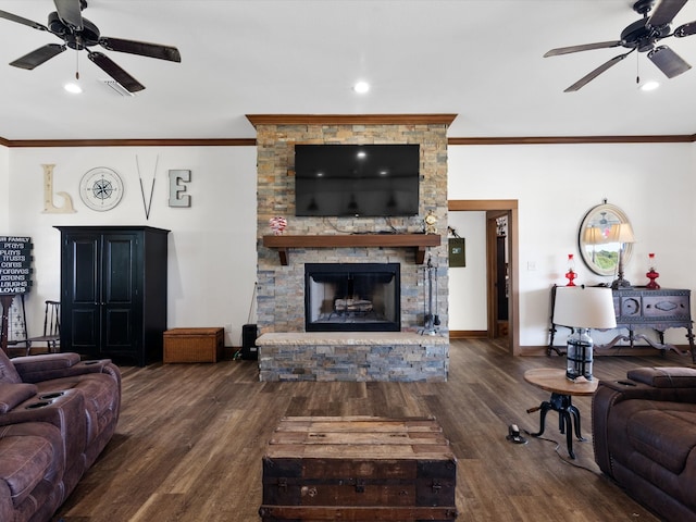 living room featuring ornamental molding, dark wood-type flooring, a fireplace, and ceiling fan