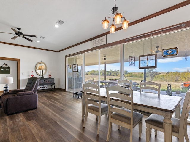 dining room with ornamental molding, ceiling fan with notable chandelier, and dark hardwood / wood-style flooring