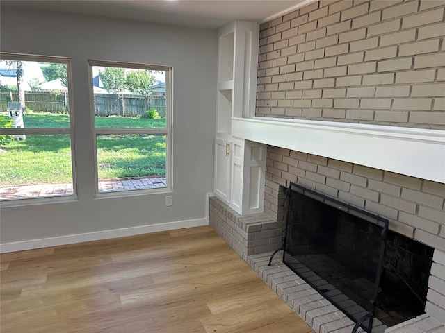 details featuring a brick fireplace and hardwood / wood-style floors