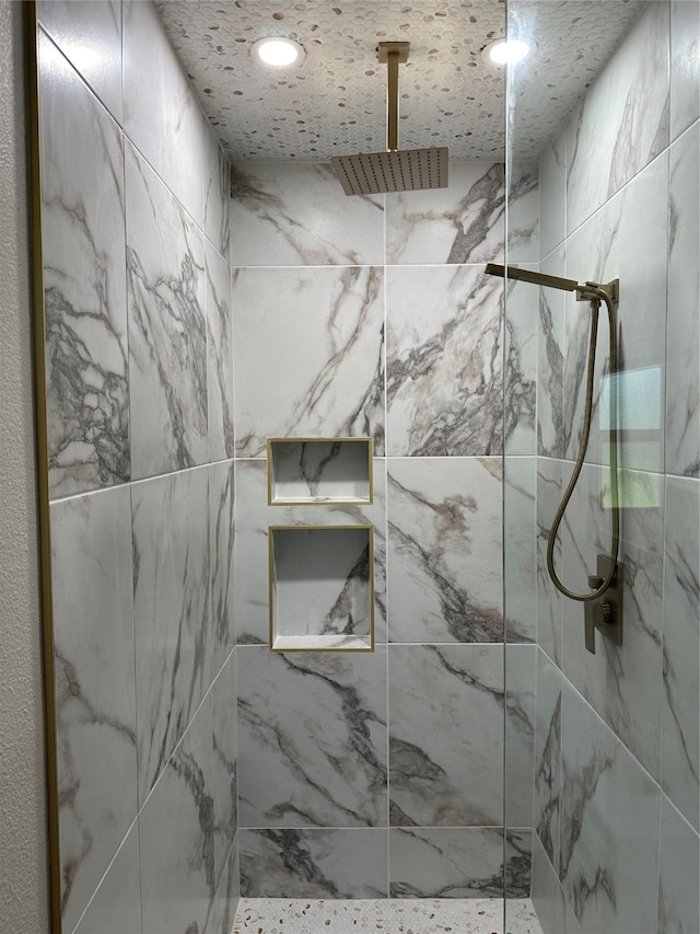 bathroom with a tile shower