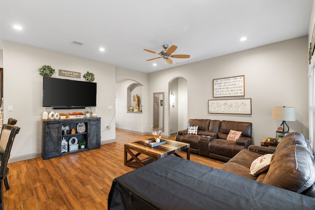 living room featuring hardwood / wood-style floors and ceiling fan